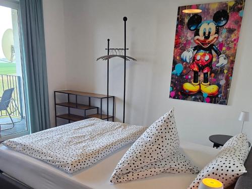 a bedroom with a mickey mouse painting on the wall at RINGZEIT-Lodge in Herresbach