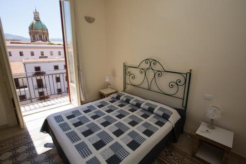 a bedroom with a bed and a large window at Massimissimo in Palermo