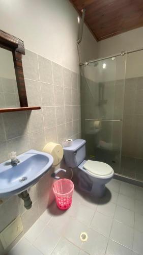 a bathroom with a toilet and a sink at Hotel kerana moon in Puerto Boyacá