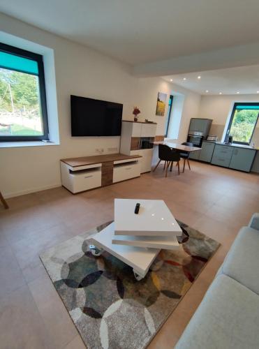a living room with a couch and a tv at Em Klaus sei Haus in Pirmasens