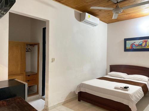 a bedroom with a bed and a tv in it at Hotel kerana moon in Puerto Boyacá