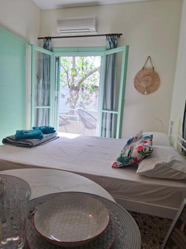 a bedroom with a large bed with a glass table at Vitamin sea Apartment 4, Άνετο διαμέρισμα. in Almiropótamos