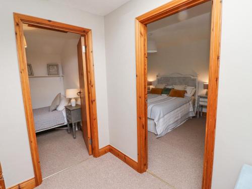 a mirror in a room with a bed at Edendale in Longframlington