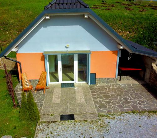 an orange and blue building with a glass door at Apartment Ozebek in Cerkno