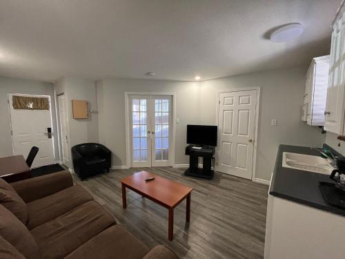 a living room with a couch and a table at Lakeshore Suites in North Bay