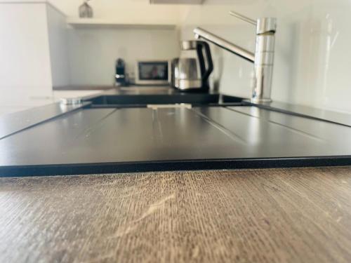 a kitchen with a counter top on a wooden floor at Ferienhaus am Tor zur Wachau in Eggendorf