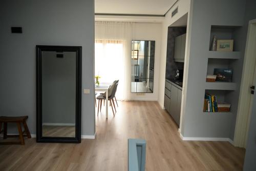 a living room with a mirror and a table at Domus Revado in Birštonas