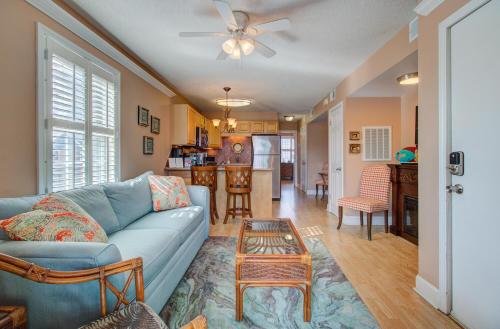 a living room with a blue couch and a table at Driftwood Villa 101 by Carolina Beach Realty in Carolina Beach