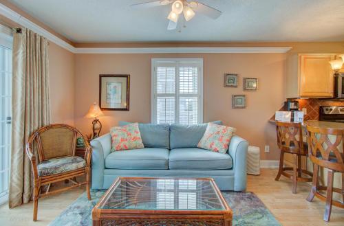 a living room with a blue couch and a table at Driftwood Villa 101 by Carolina Beach Realty in Carolina Beach