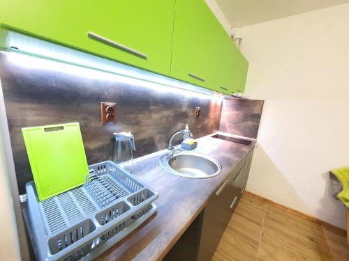 a kitchen counter with a sink and a green cabinet at Path ways to the Sea -Пътека към морето in Primorsko