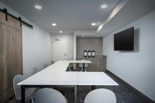 a conference room with a white table and chairs at TownePlace Suites by Marriott Annapolis in Annapolis