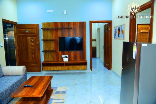 a living room with a couch and a coffee table at Deluxe AC Room by Omicron Comforts-Manyata Tech Park in Bengaluru