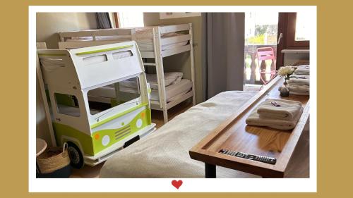 a bedroom with bunk beds and a bed with a table at Berghupferl-Alm - do legst di nieda in Flintsbach am Inn