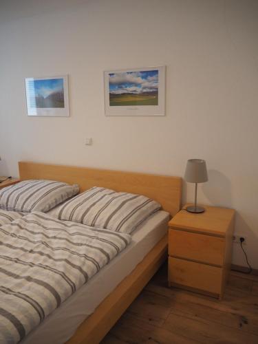 a bedroom with a bed and a table with a lamp at Ferienwohnung Dinkelbergblick in Wehr