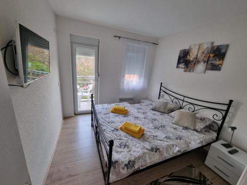 a bedroom with a bed with yellow pillows on it at Nada-S in Soko Banja
