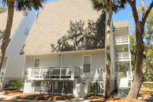a white house with a white fence in front of it at Driftwood Villa - 269 in Edisto Island