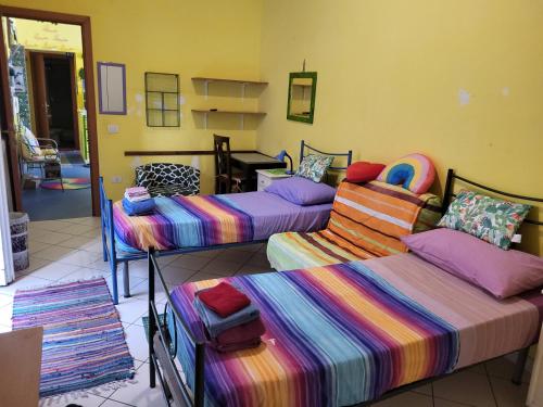 a room with three beds and a desk in it at Bed-Letto-Cama in Shared Room Camera Condivisa in Naples