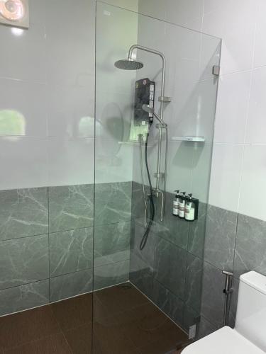 a shower with a glass door in a bathroom at The Rice Chiang Dao in Ban Thung Lakhon