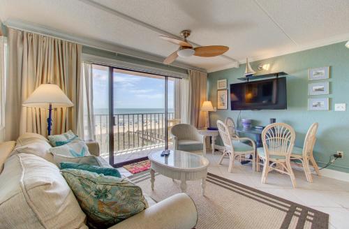 a living room with a couch and a table at Good Tidings 2U by Carolina Beach Realty in Carolina Beach