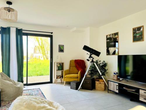 un salon avec une télévision et une chaise jaune dans l'établissement Brikenn - Ideal Country Loft for Families & Couples, à Trébeurden