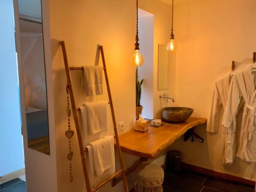 a bathroom with a sink and a mirror at La Perle du Voyageur in Agde