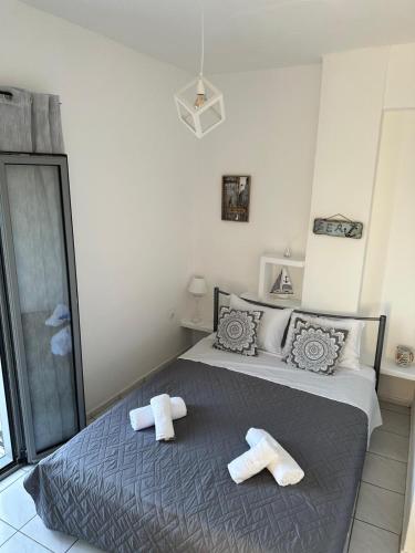 a bedroom with a bed with towels on it at Calypso Heaven in Santorini