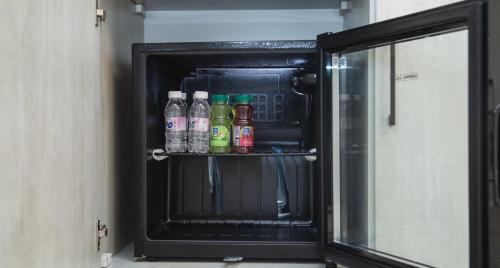 a small refrigerator with drinks inside of it at Quiet Studio with Smart Entry Roses in Jeddah