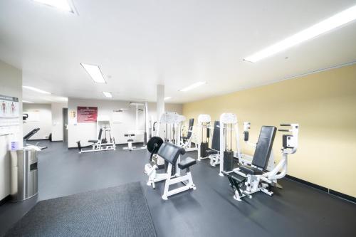 a gym with several treadmills and machines at Modern Downtown Top Floor Penthouse With Bay Views in Seattle