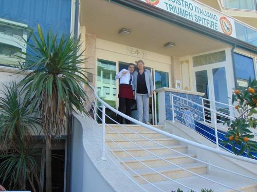 two people standing on the stairs of a building at Hotel Lady Mary in Milano Marittima