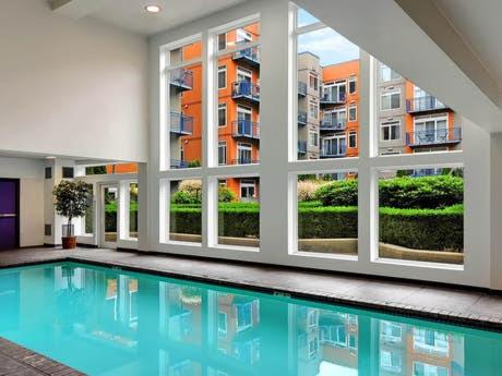 a large swimming pool in a building with windows at Penthouse Suite Downtown, Top Floor in Seattle