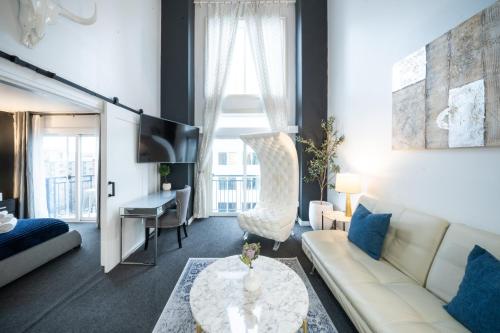 a living room with a couch and a table at Space Needle Downtown Modern Top Story Penthouse in Seattle