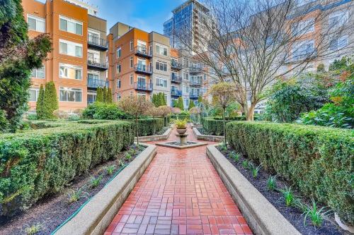 a brick walkway with a fountain in a city at Space Needle Downtown Modern Top Story Penthouse in Seattle