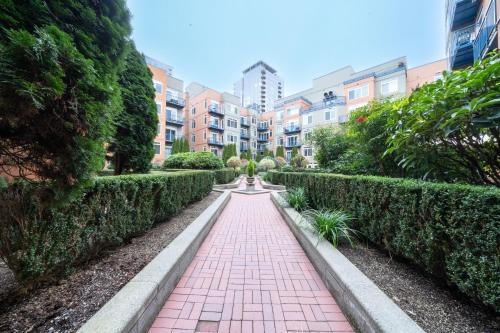 a red brick walkway in a park with buildings at Space Needle Downtown Modern Top Story Penthouse in Seattle