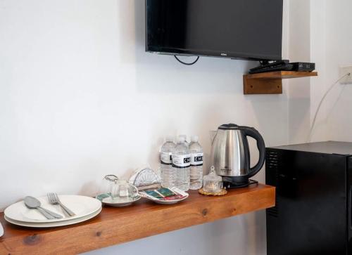 a kitchen counter with a coffee pot and dishes on it at cmb apartments in Negombo