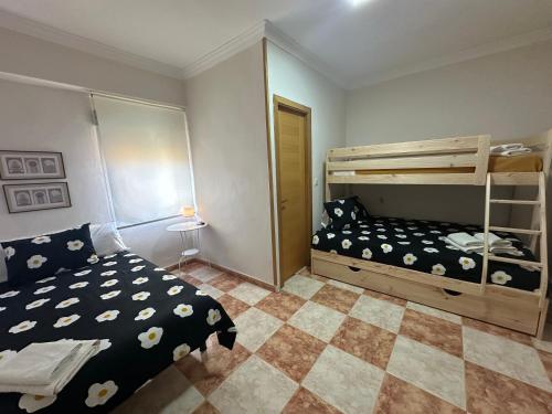 a bedroom with a bed and a bunk bed at Hostal J&C in Olula del Río