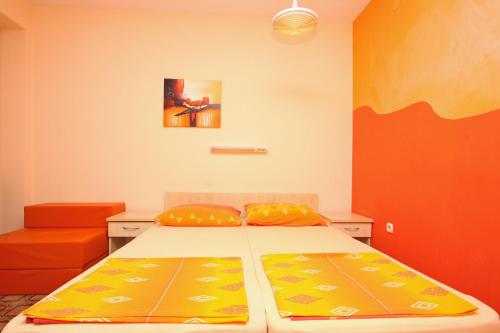 a bedroom with a bed and a painting on the wall at Apartments and Rooms Vesna Novalja in Novalja