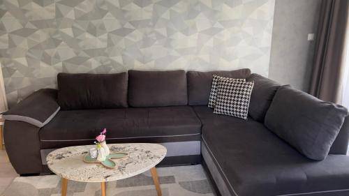 a black couch with a table in a living room at Luxury Stays Kapana Plovdiv in Plovdiv