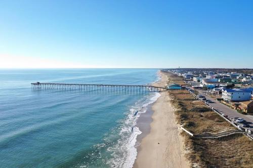 an aerial view of a beach with a pier at Nautical Nook by Carolina Beach Realty in Carolina Beach