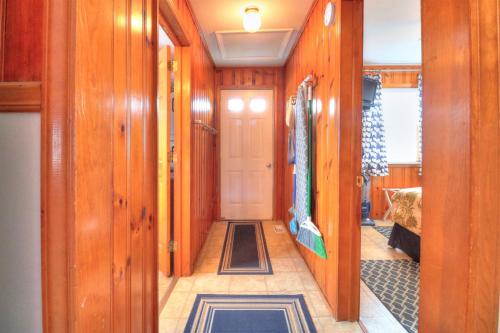 a hallway with wood paneled walls and a door at Nautical Nook by Carolina Beach Realty in Carolina Beach