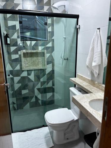 a bathroom with a shower and a toilet and a sink at Hachi Flats - GRU in Guarulhos