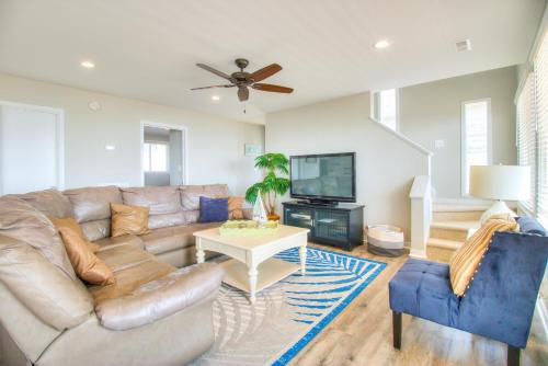a living room with a couch and a tv at Next Time Down by Carolina Beach Realty in Kure Beach
