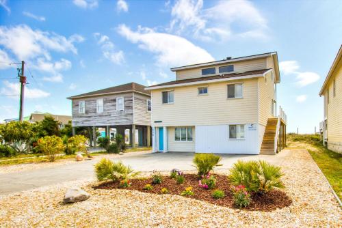 a large house with a driveway at Next Time Down by Carolina Beach Realty in Kure Beach