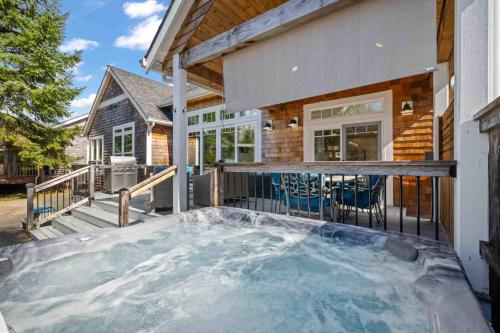 a house with a large hot tub in the backyard at The Nedonna Nest in Rockaway Beach