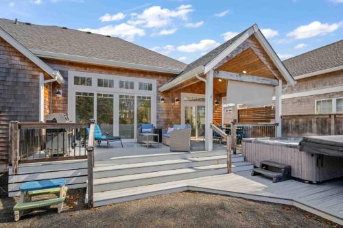 a house with a deck with a grill at The Nedonna Nest in Rockaway Beach