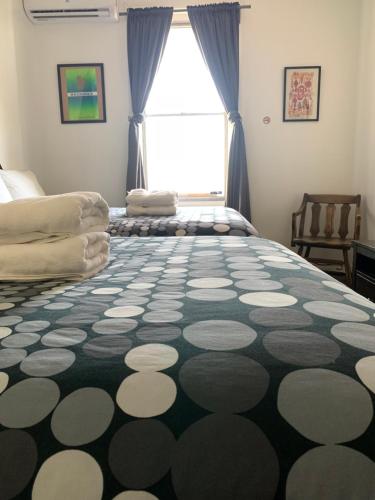 a bedroom with a large bed and a window at Pensione Popolo in Montréal