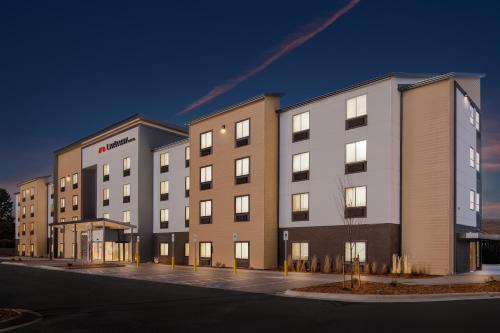 a large building with lights on in a parking lot at LivAway Suites Missoula in Missoula