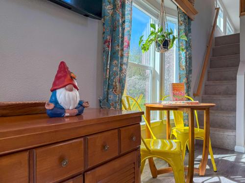 a doll sitting on top of a dresser in a room at Apple Blossom Bungalow in Sequim