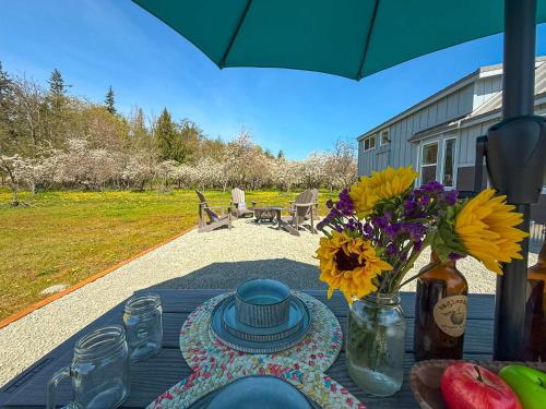 a table with a blue table cloth and flowers on it at Apple Blossom Bungalow in Sequim