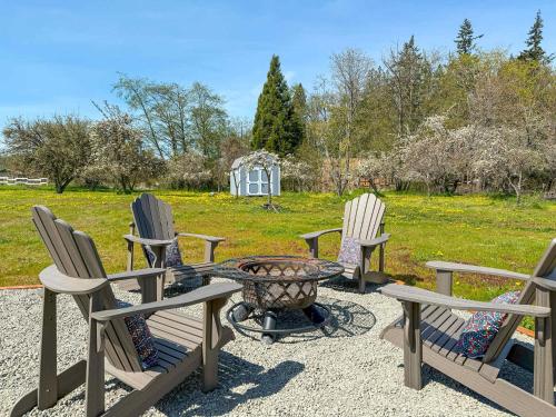 a group of chairs and a table with a fire pit at Apple Blossom Bungalow in Sequim
