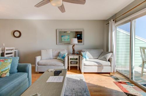 a living room with a couch and chairs and a ceiling fan at Ocean Dunes 1504 by Carolina Beach Realty in Kure Beach